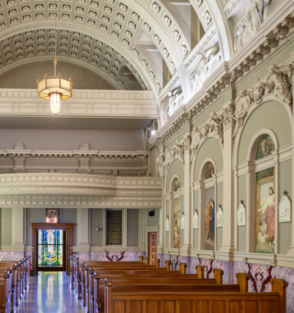 1904 chapel nave with pews and murals